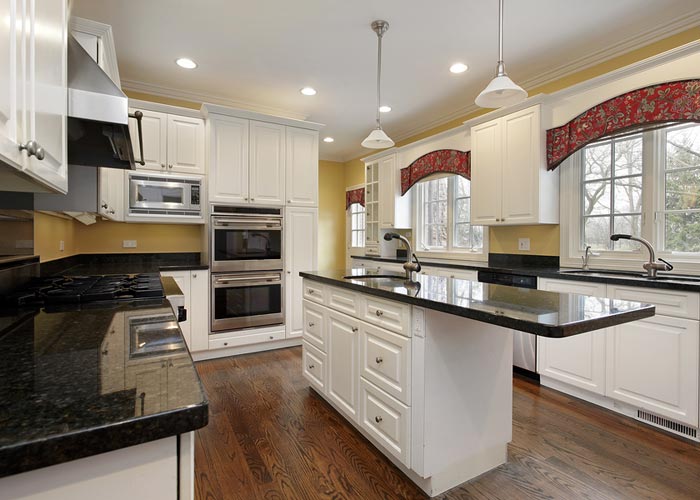 Before photo of a Downey CA kitchen remodel showing outdated cabinets and layout