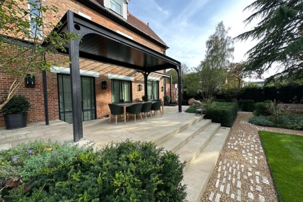 After photo of transformed outdoor living space with patio and fire pit